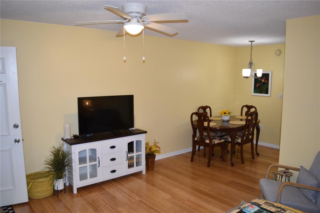 4746 Azalea Drive, Unit 208C New Port Richey, FL 34652 - Photo 8 of 56 a view of a workspace with furniture and wooden floor