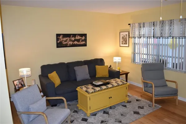 a living room with furniture and a floor to ceiling window