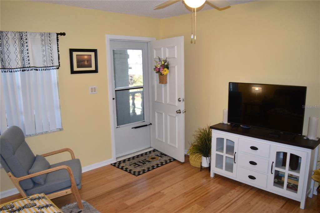 4746 Azalea Drive, Unit 208C New Port Richey, FL 34652 - Photo 10 of 56 a room with furniture and a flat screen tv