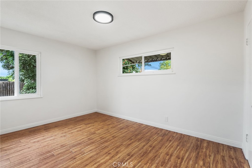 13361 Roxey Drive Garden Grove, CA 92843 - Photo 17 of 31 an empty room with wooden floor and windows