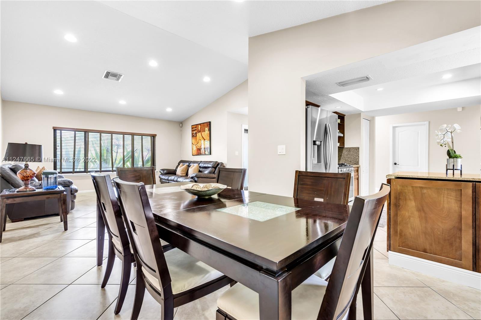 11809 Southwest 95th Street Miami, FL 33186 - Photo 11 of 25 a view of a dining room with furniture and a livingroom
