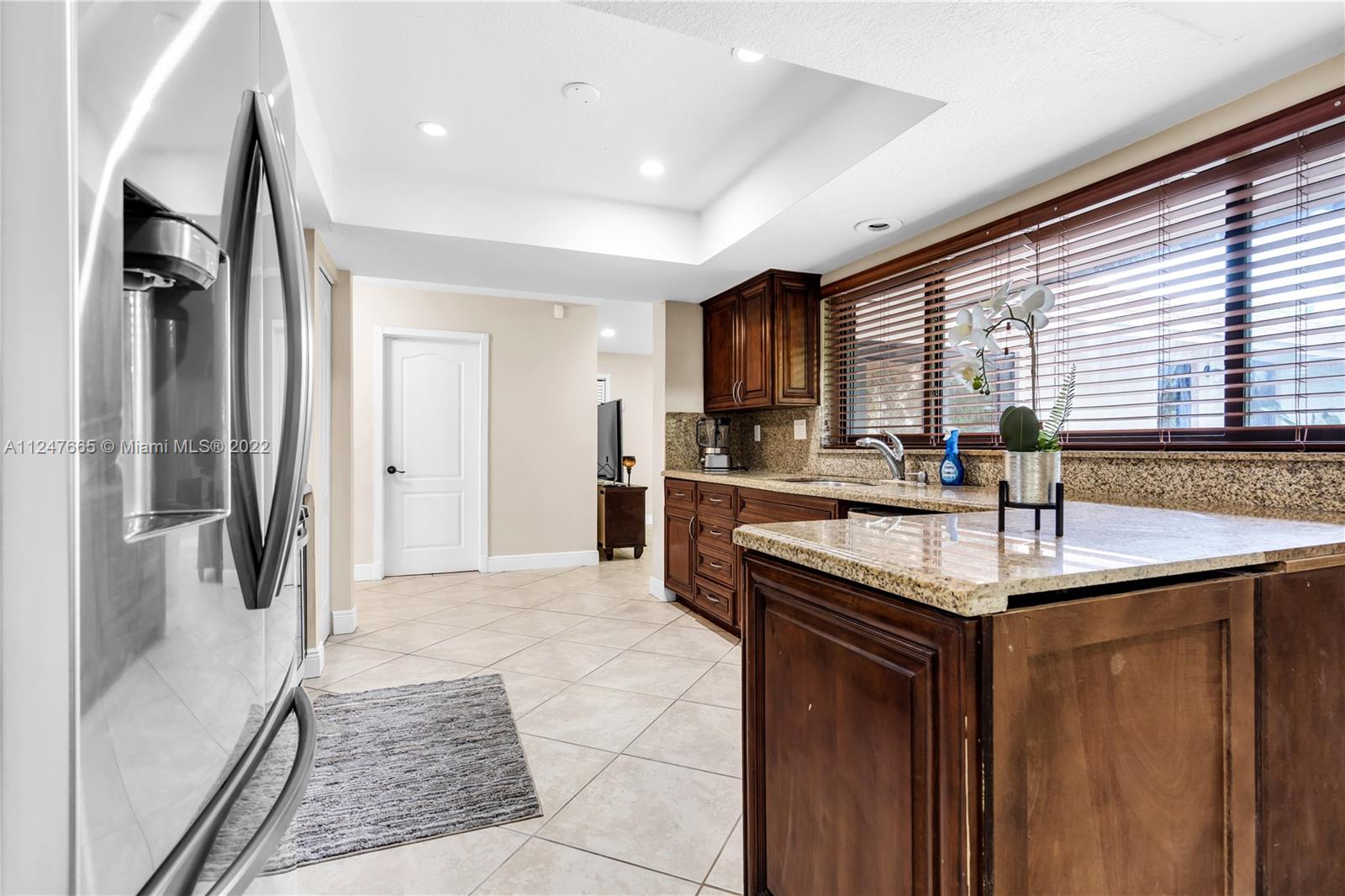 11809 Southwest 95th Street Miami, FL 33186 - Photo 12 of 25 a kitchen with stainless steel appliances granite countertop a sink stove and refrigerator