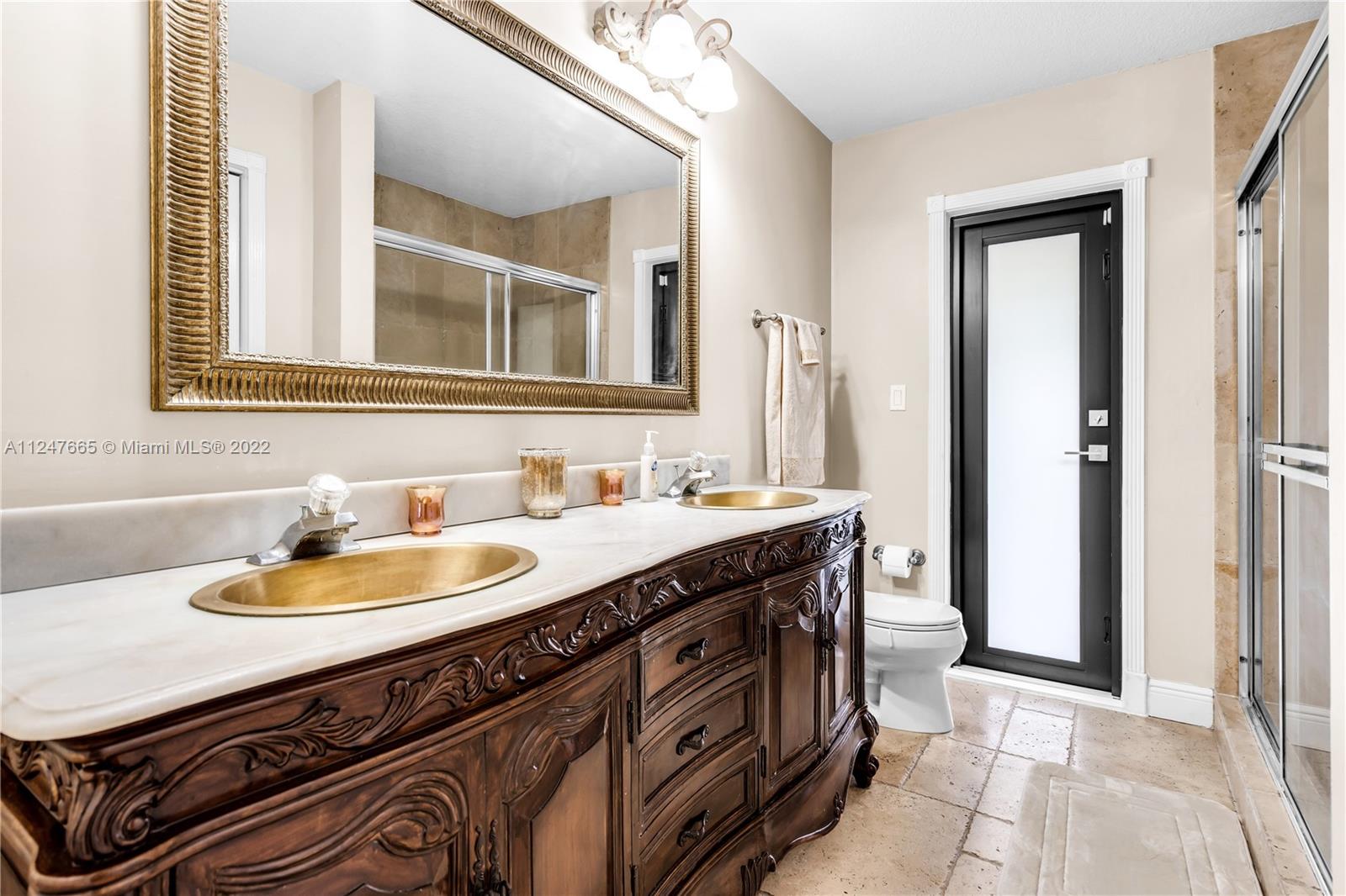 11809 Southwest 95th Street Miami, FL 33186 - Photo 15 of 25 a bathroom with a sink and a mirror