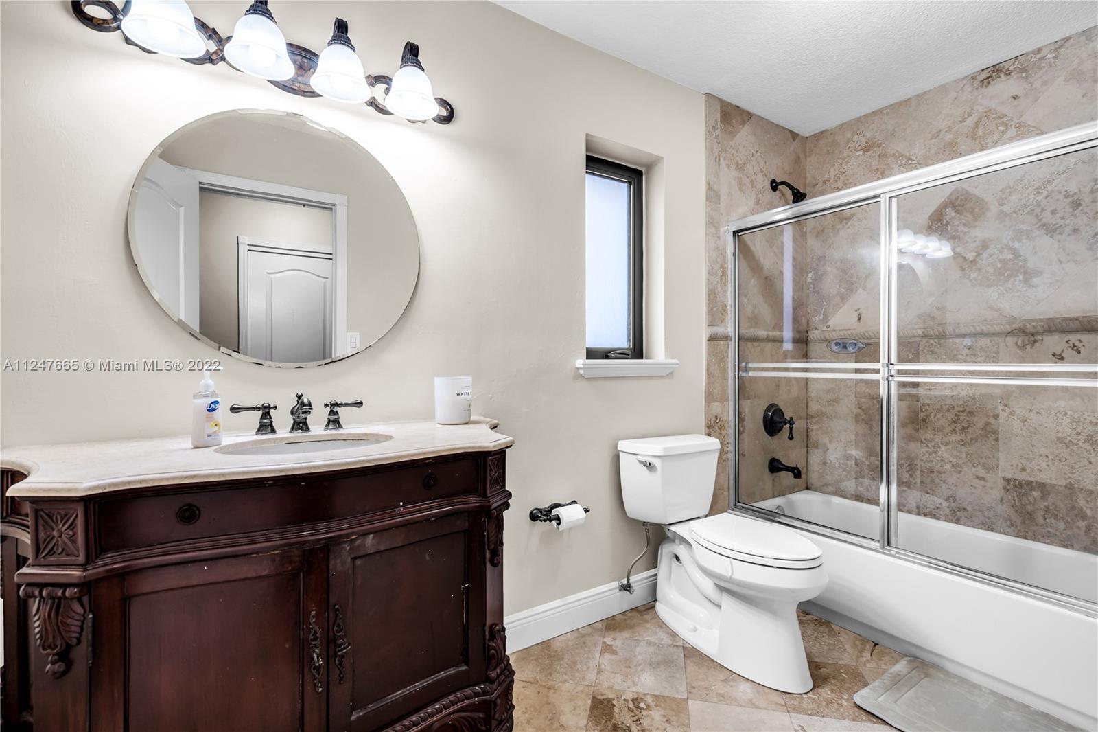 11809 Southwest 95th Street Miami, FL 33186 - Photo 16 of 25 a bathroom with a toilet sink and mirror