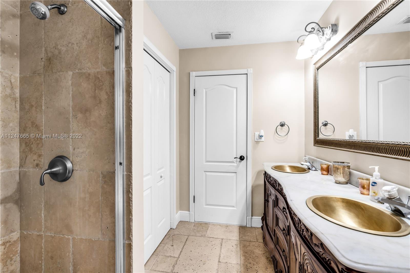 11809 Southwest 95th Street Miami, FL 33186 - Photo 17 of 25 a bathroom with a sink a toilet and shower