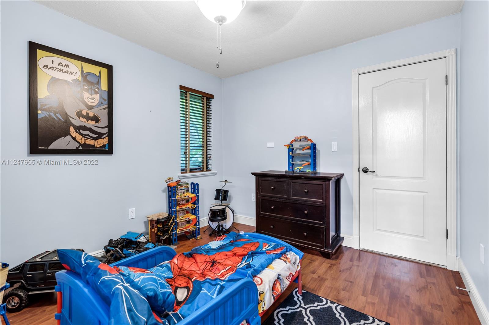 11809 Southwest 95th Street Miami, FL 33186 - Photo 20 of 25 a bedroom with a bed and wooden floor