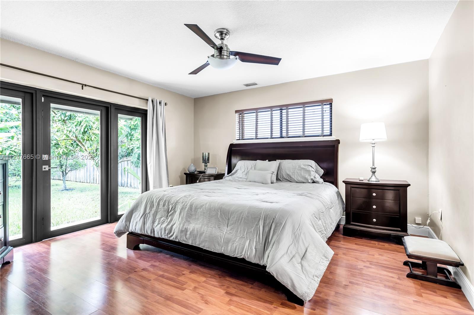 11809 Southwest 95th Street Miami, FL 33186 - Photo 21 of 25 a bedroom with a bed and a large window