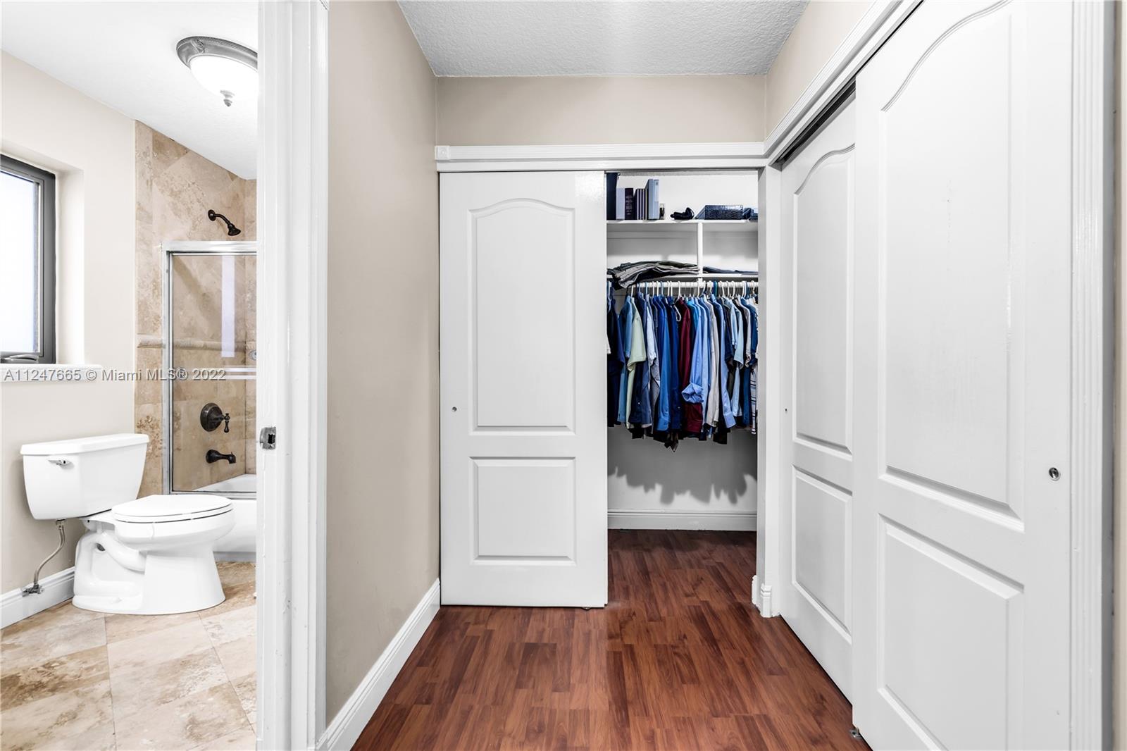 11809 Southwest 95th Street Miami, FL 33186 - Photo 23 of 25 a walk in closet with wooden floor