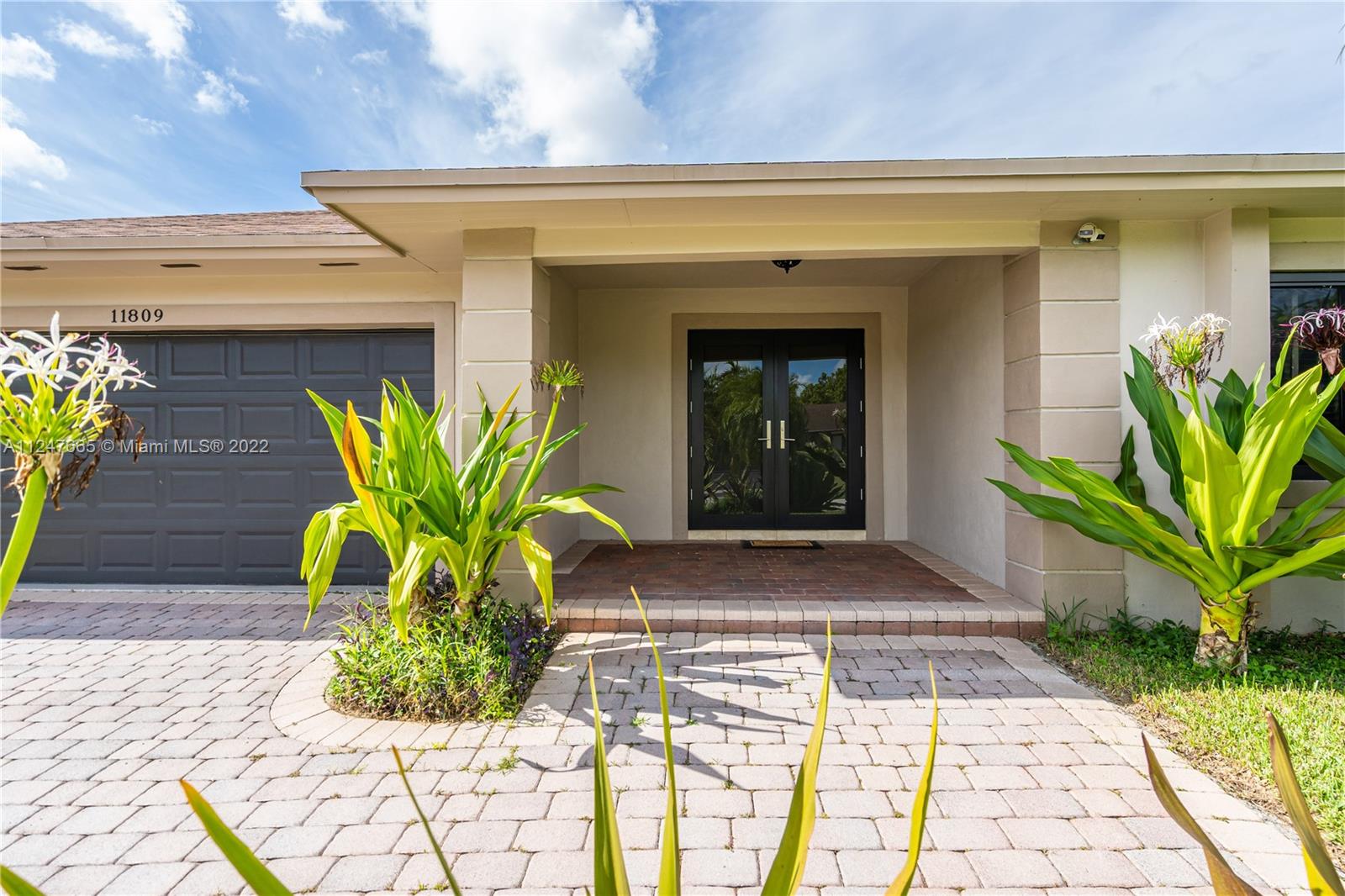 11809 Southwest 95th Street Miami, FL 33186 - Photo 3 of 25 a view of front door of house with outdoor seating