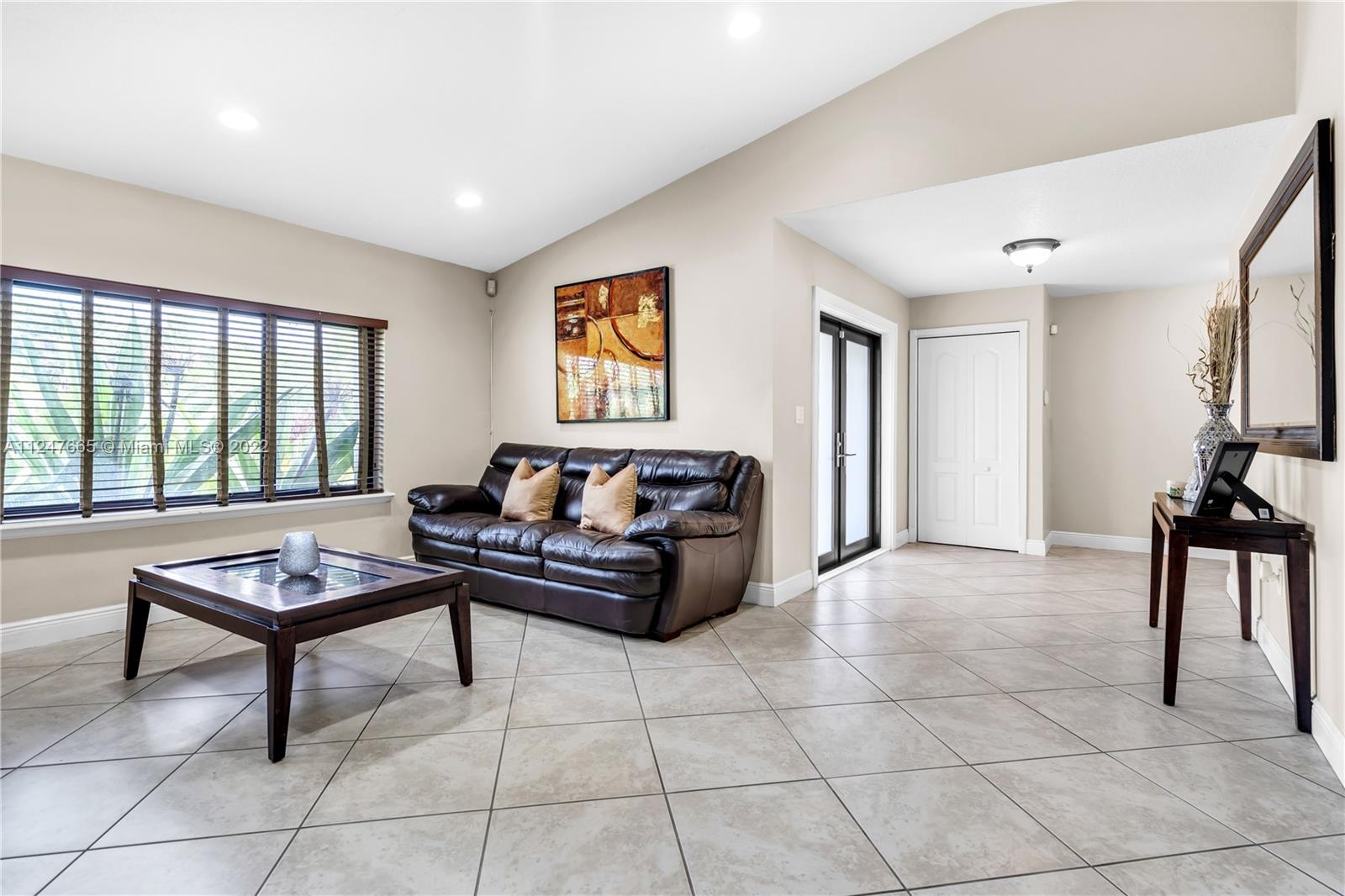 11809 Southwest 95th Street Miami, FL 33186 - Photo 6 of 25 a living room with furniture and a window