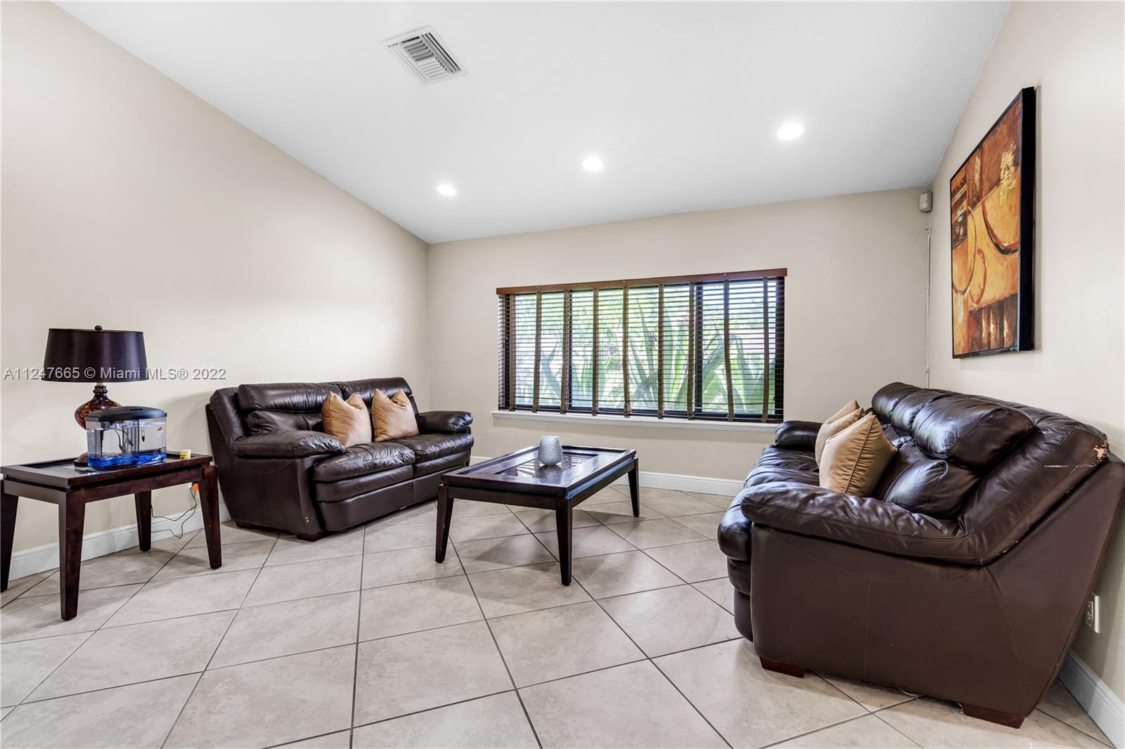 11809 Southwest 95th Street Miami, FL 33186 - Photo 7 of 25 a living room with furniture and a window