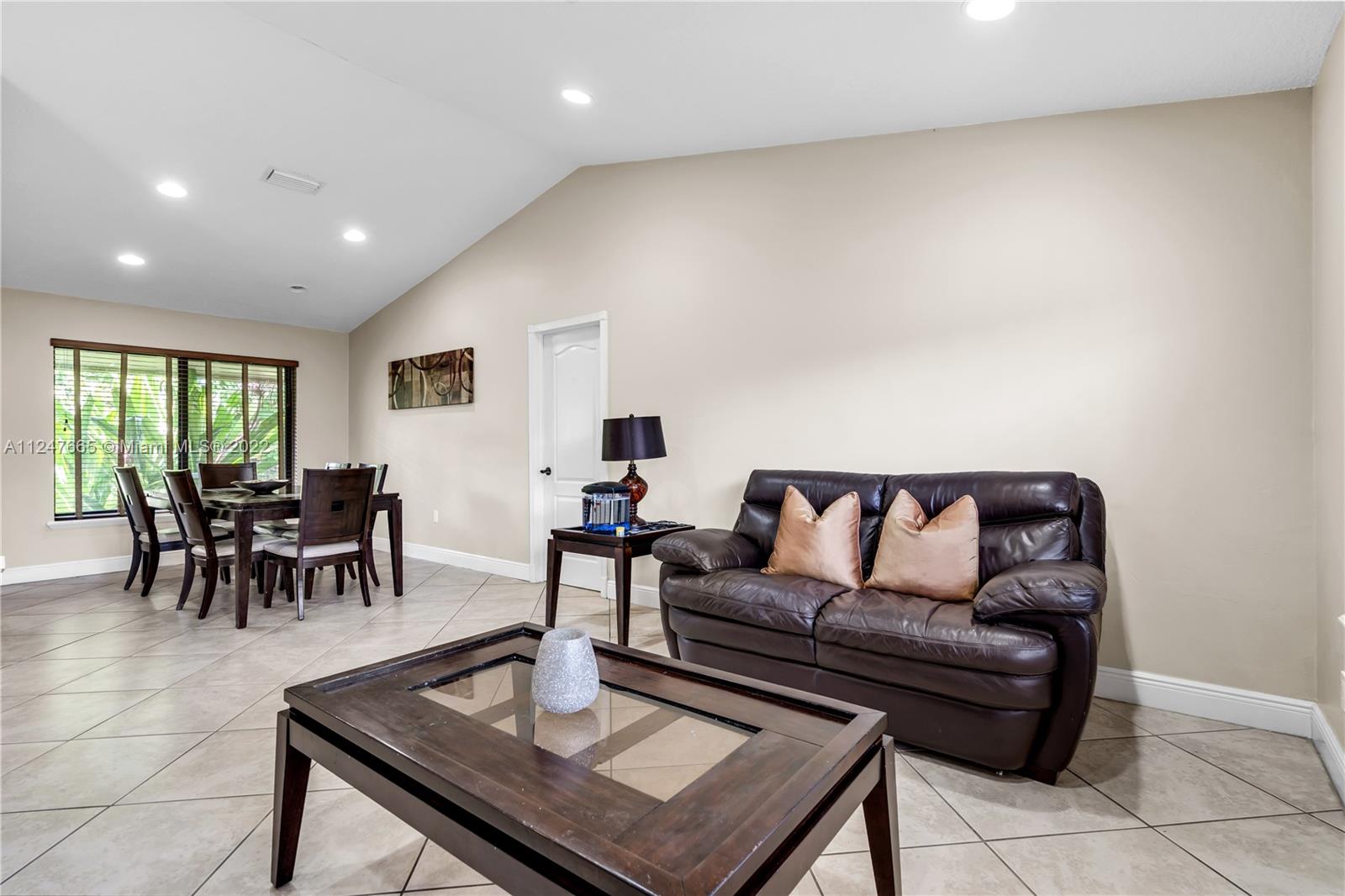 11809 Southwest 95th Street Miami, FL 33186 - Photo 9 of 25 a living room with furniture and a table