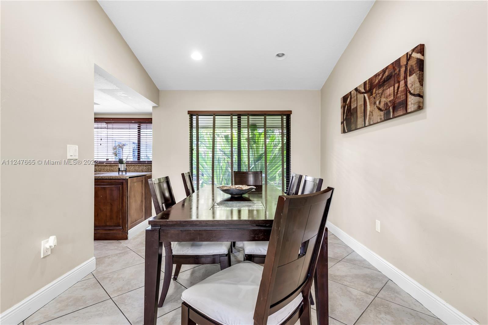 11809 Southwest 95th Street Miami, FL 33186 - Photo 10 of 25 a view of a dining room with furniture window and outside view