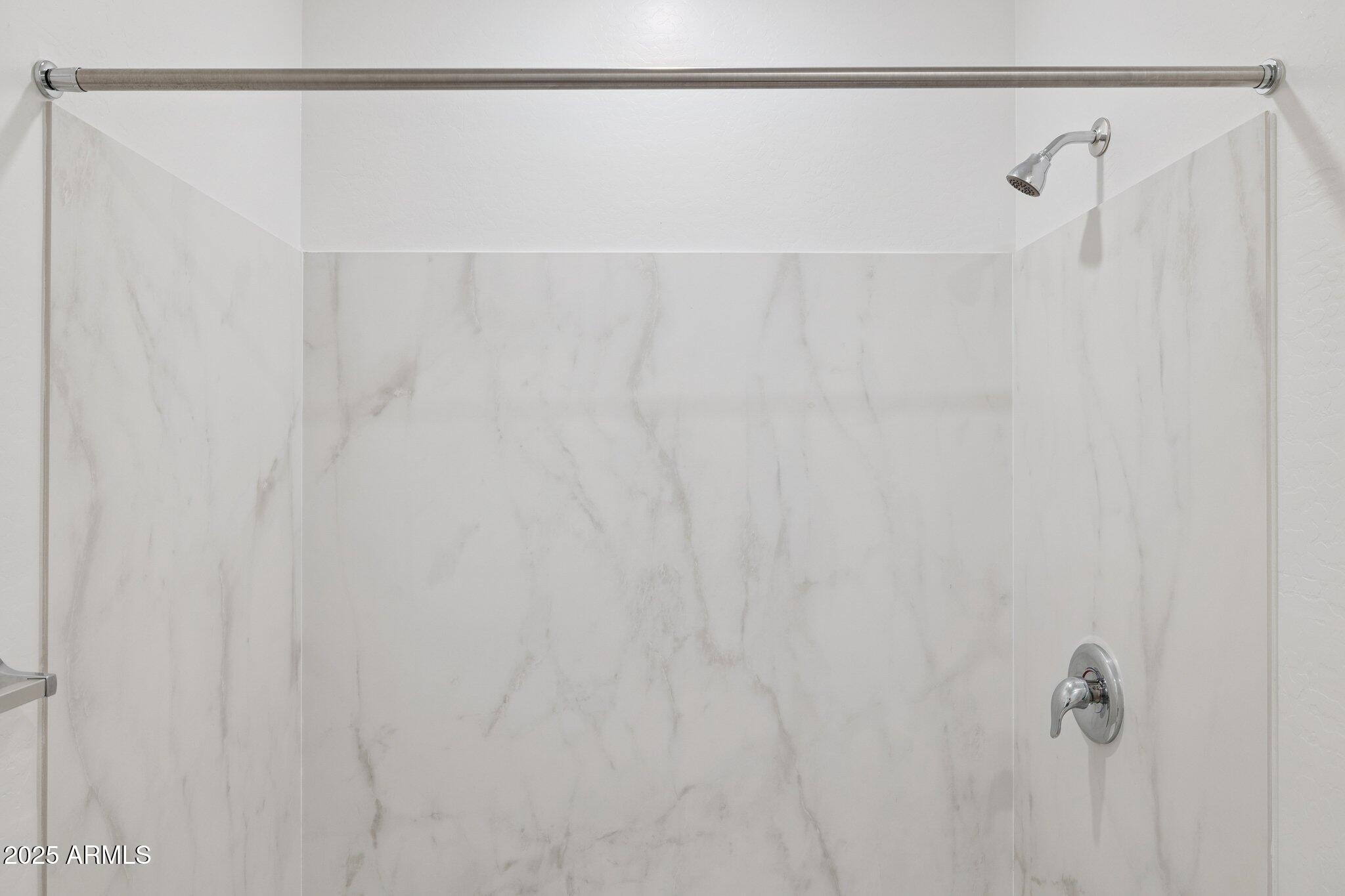 25453 West Fraktur Road Buckeye, AZ 85326 - Photo 11 of 18 a bathroom with a shower curtain