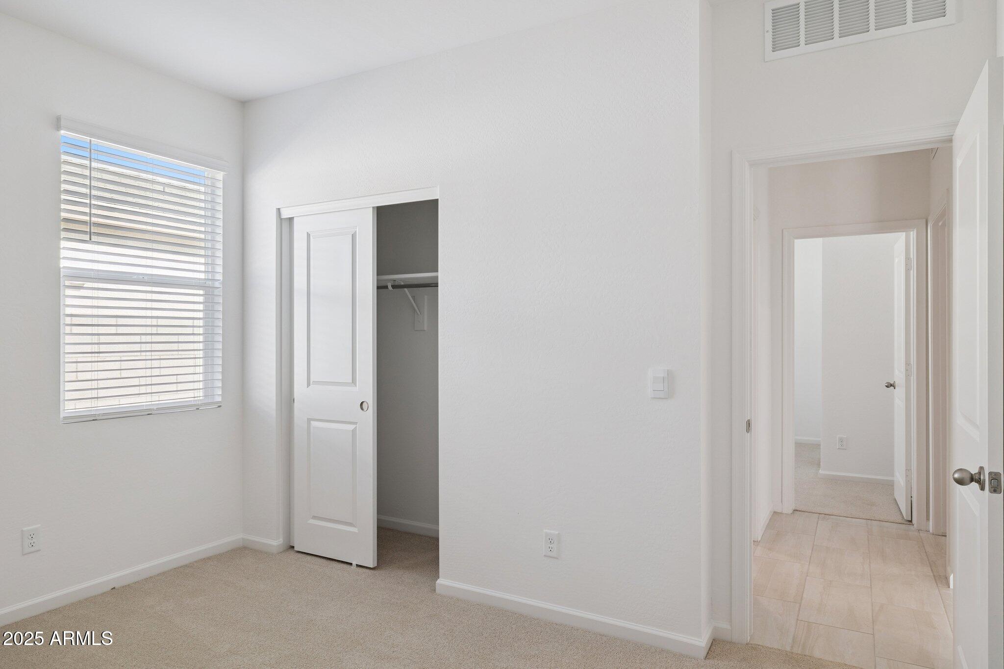 25453 West Fraktur Road Buckeye, AZ 85326 - Photo 12 of 18 an empty room with windows