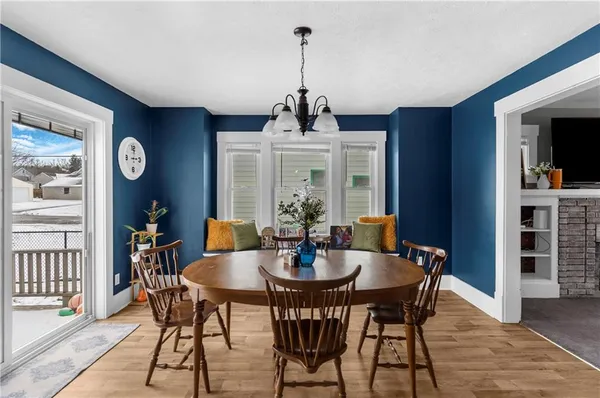 a view of a dining room with furniture wooden floor and a chandelier