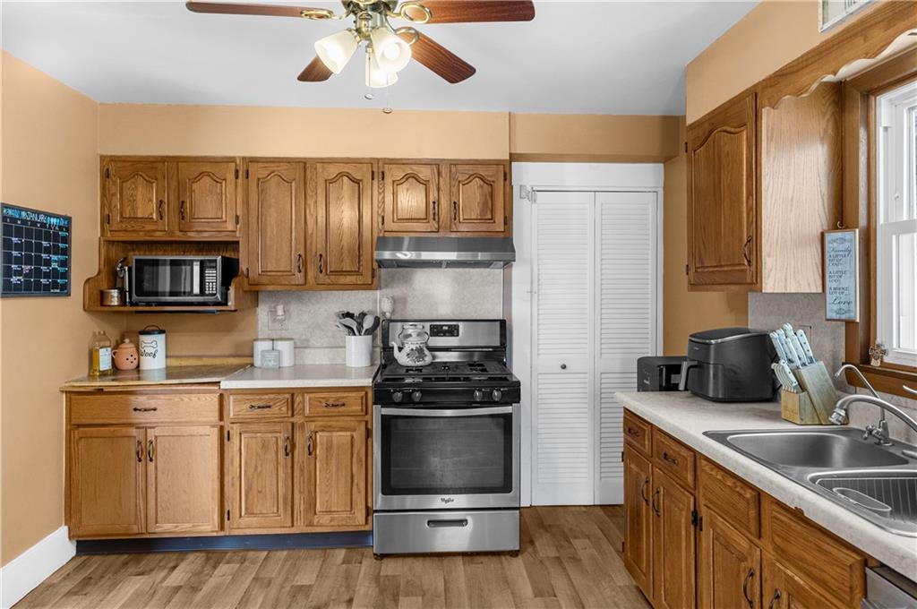 1571 West Ridge Avenue Sharpsville, PA 16150 - Photo 19 of 30 a kitchen with stainless steel appliances a sink stove and refrigerator