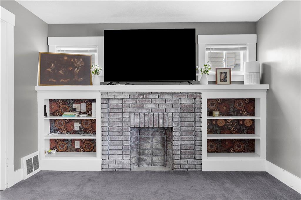 1571 West Ridge Avenue Sharpsville, PA 16150 - Photo 22 of 30 a living room with fireplace and a flat screen tv