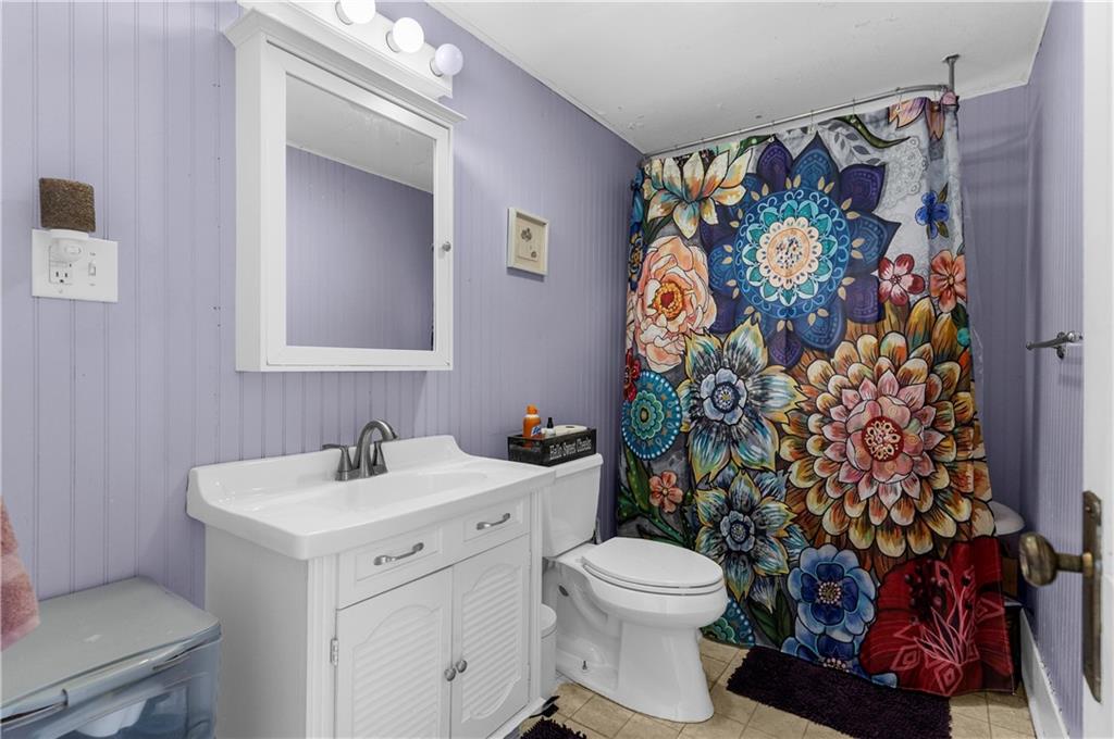 1571 West Ridge Avenue Sharpsville, PA 16150 - Photo 26 of 30 a bathroom with a toilet sink and shower curtain