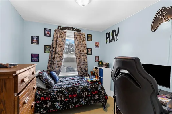 a bedroom with a bed a desk and chair