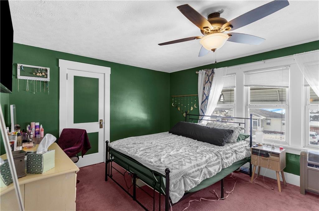 1571 West Ridge Avenue Sharpsville, PA 16150 - Photo 30 of 30 a bedroom with a bed and a chandelier