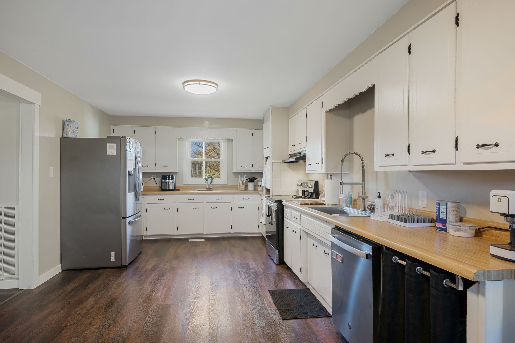 3205 Sylvia Road Dickson, TN 37055 - Photo 5 of 26 a kitchen with a sink a refrigerator a stove and cabinets