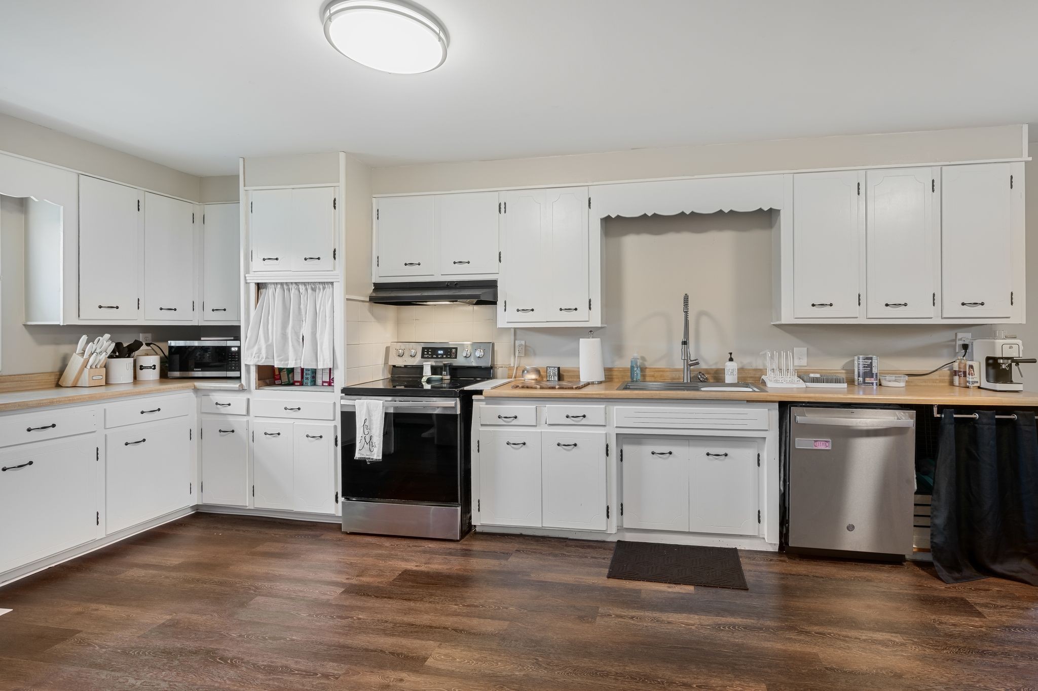 3205 Sylvia Road Dickson, TN 37055 - Photo 6 of 26 a kitchen with granite countertop white cabinets and white appliances