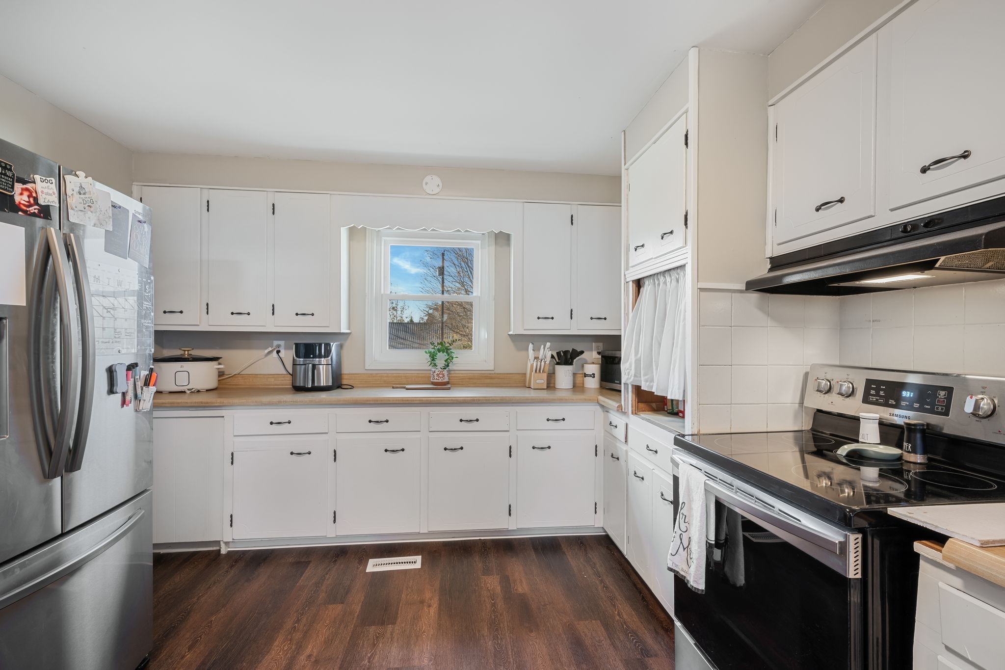 3205 Sylvia Road Dickson, TN 37055 - Photo 8 of 26 a kitchen with cabinets wooden floor and stainless steel appliances