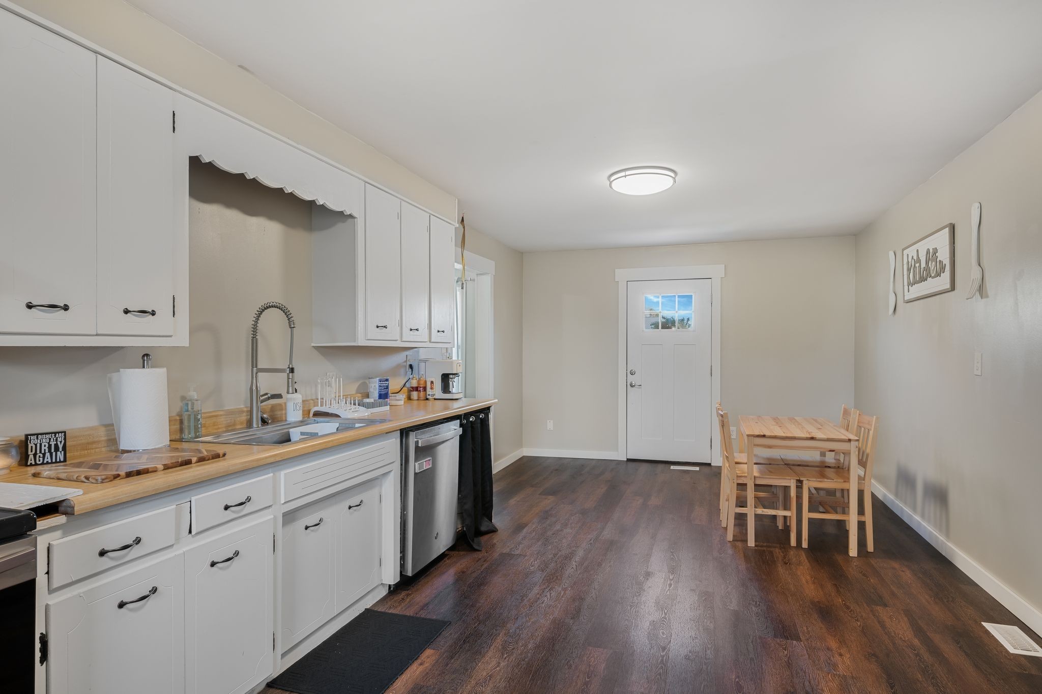 3205 Sylvia Road Dickson, TN 37055 - Photo 9 of 26 a kitchen with a sink cabinets and wooden floor