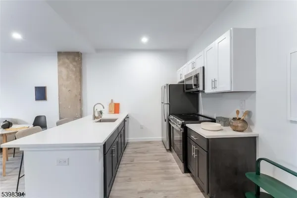 a kitchen with a sink stove and cabinets