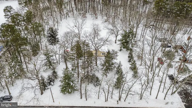 a view of a house with a yard covered in snow