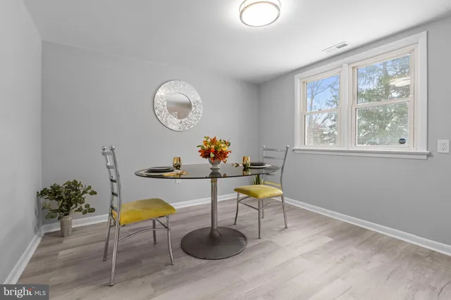 a living room with couches a table and a potted plant