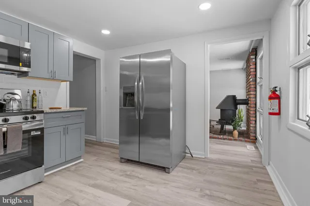 a kitchen with stainless steel appliances granite countertop a refrigerator and a sink