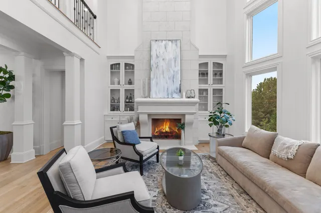 a kitchen with stainless steel appliances granite countertop a table chairs sink and cabinets