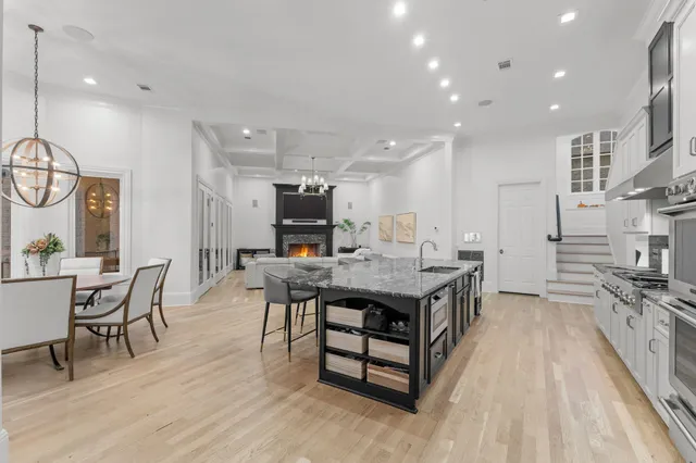 a kitchen with stainless steel appliances granite countertop a sink stove and cabinets