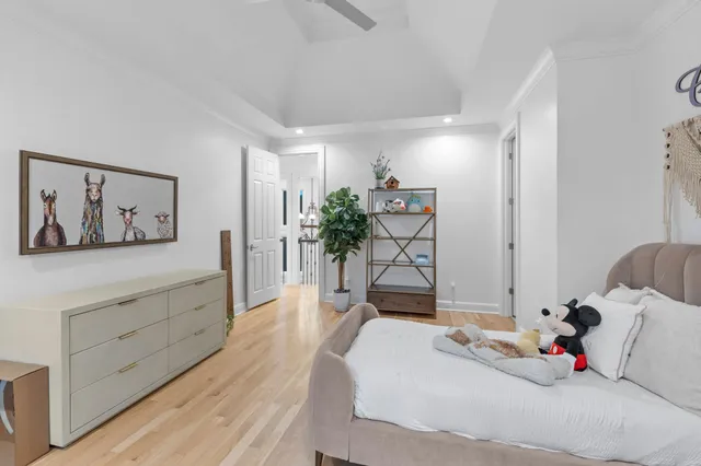 a spacious bedroom with a large bed and a large window