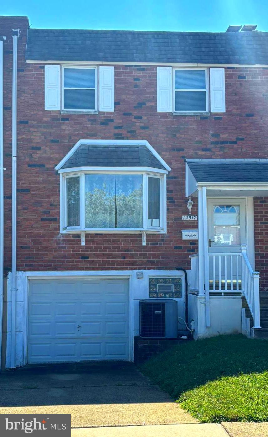 a view of a brick house with a yard