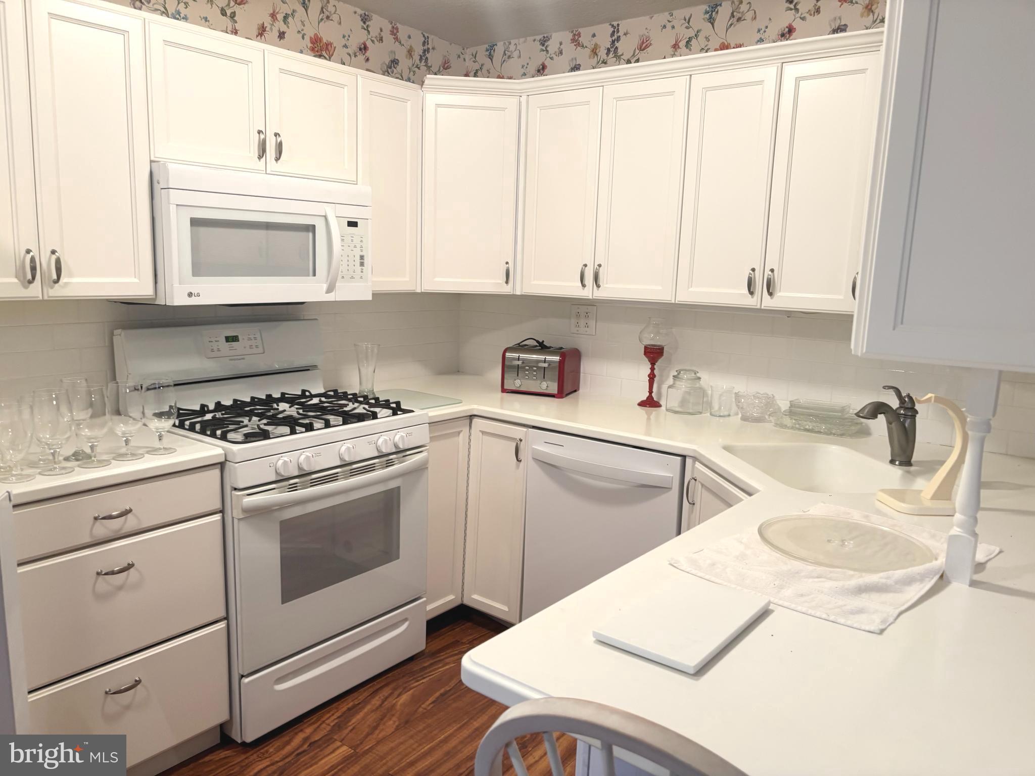 12517 Ramer Road Philadelphia, PA 19154 - Photo 5 of 24 a kitchen with granite countertop white cabinets and white appliances