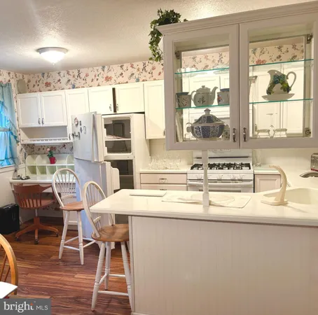 a kitchen with a window a sink and a white cabinets