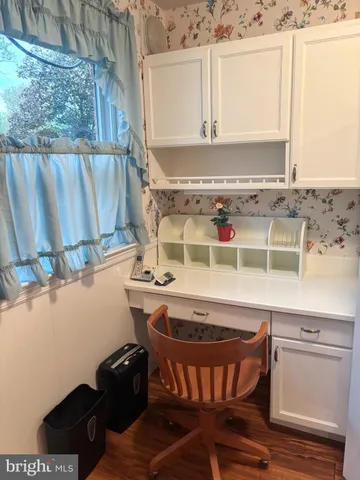 a room with a sink a window and chairs