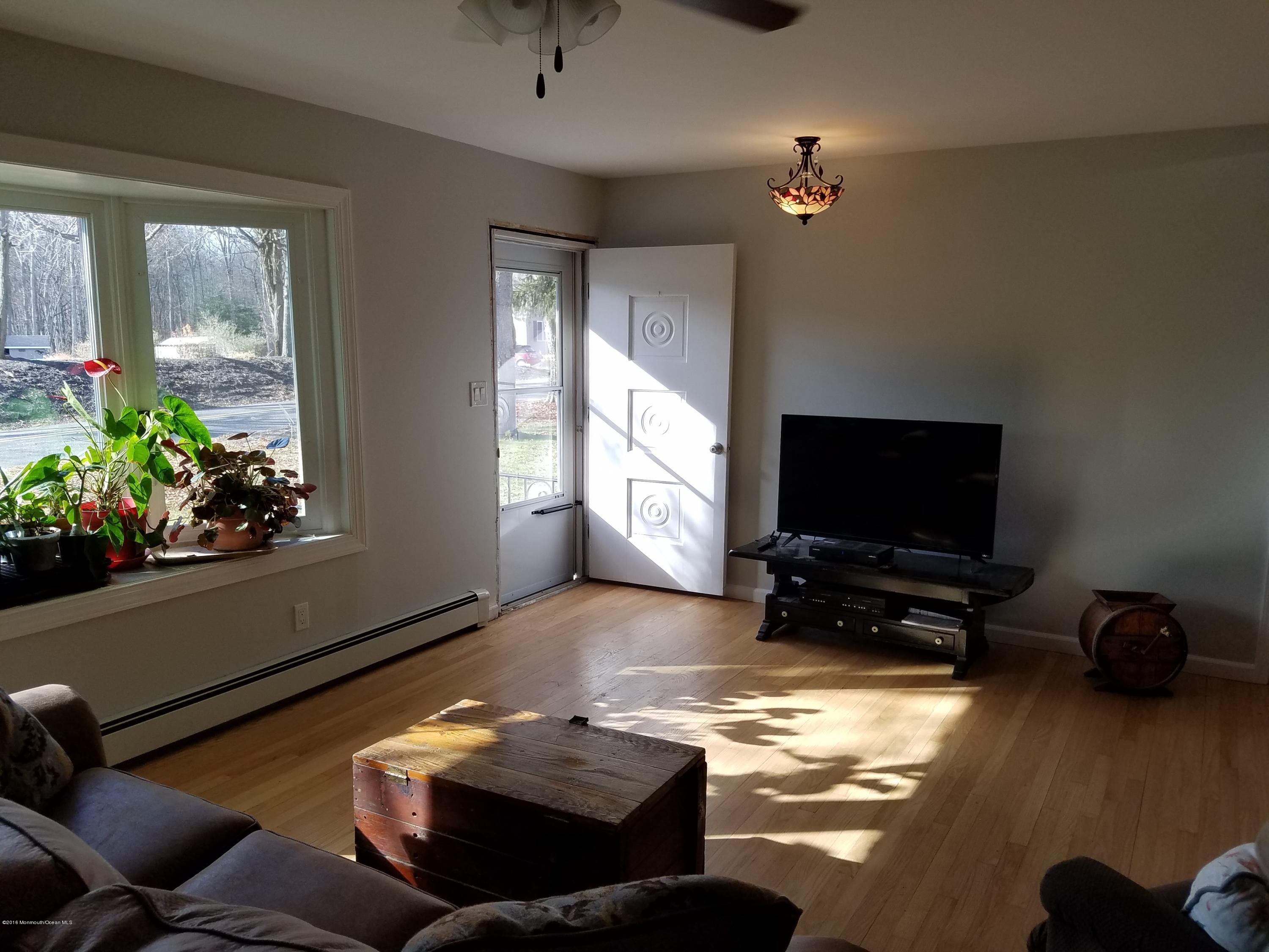 117 Maxim Road Howell, NJ 07731 - Photo 12 of 28 a living room with furniture and a flat screen tv