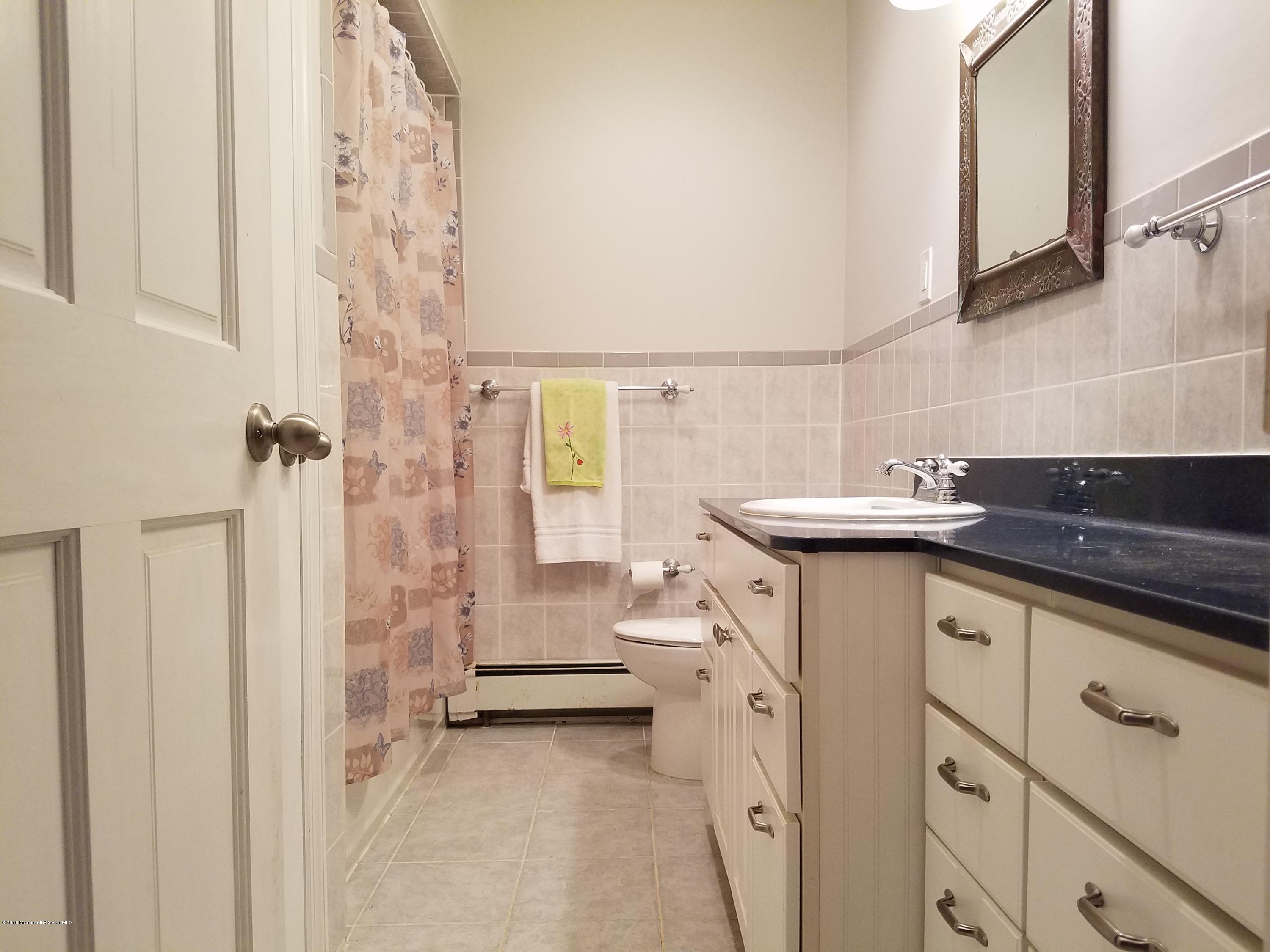 117 Maxim Road Howell, NJ 07731 - Photo 14 of 28 a bathroom with a sink and a mirror