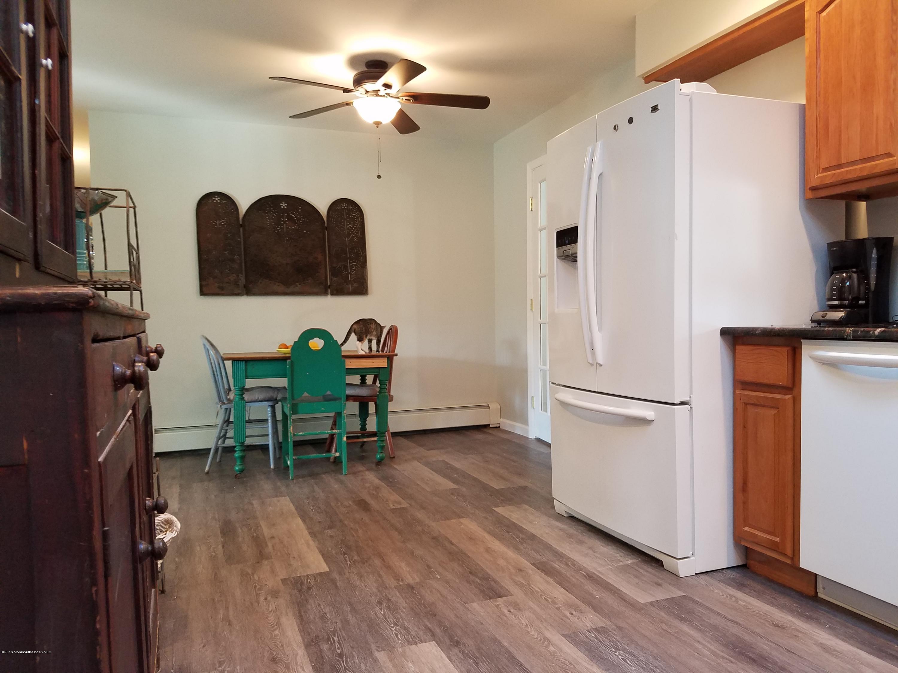 117 Maxim Road Howell, NJ 07731 - Photo 4 of 28 a view of a workspace with furniture and a refrigerator