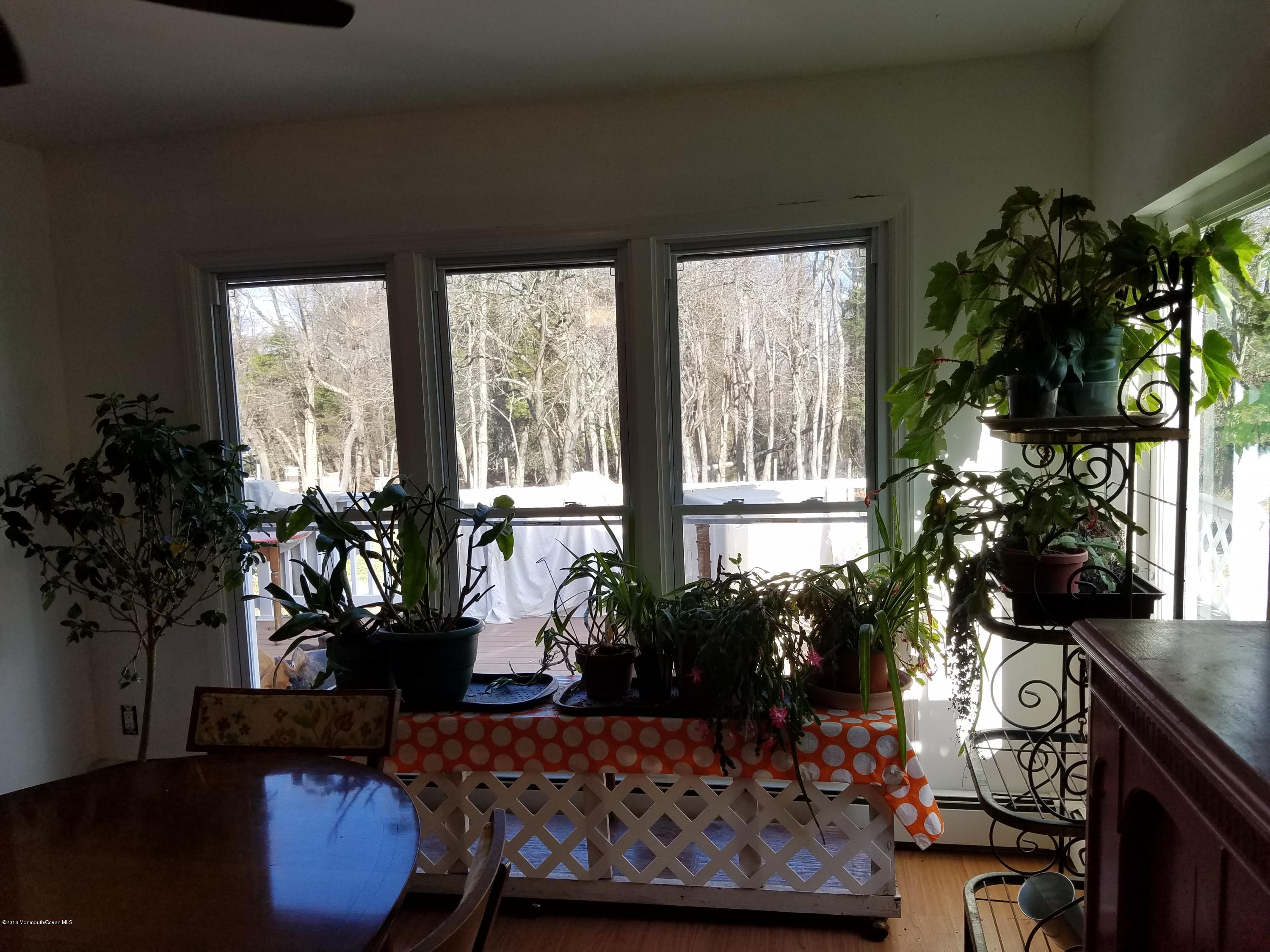 117 Maxim Road Howell, NJ 07731 - Photo 9 of 28 a living room with furniture and a potted plant