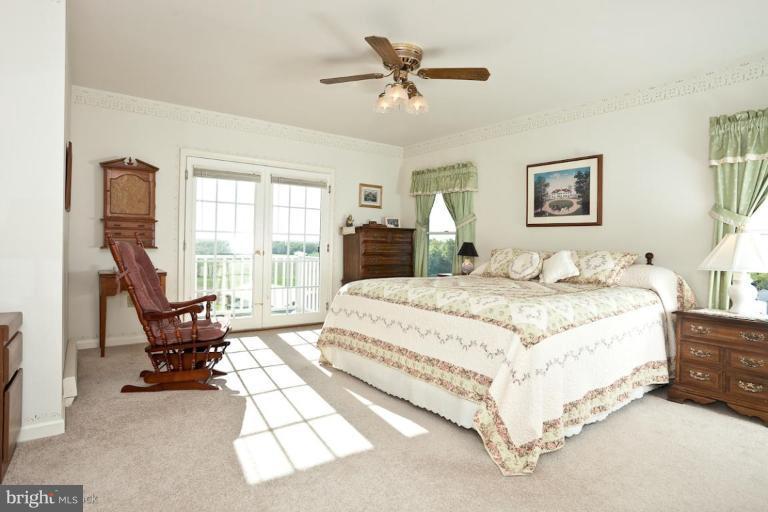 3754 Black Rock Road Upperco, MD 21155 - Photo 9 of 18 a spacious bedroom with a bed and a couch