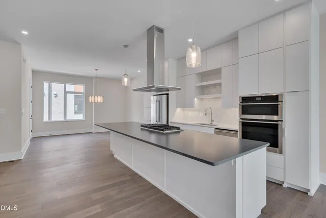 an empty room with wooden floor and balcony