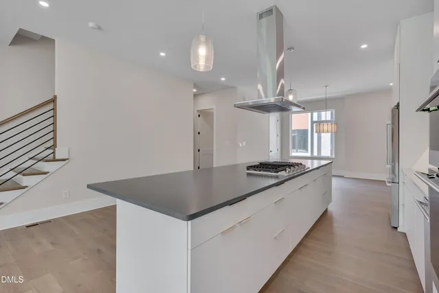 a view of kitchen and hall with wooden floor