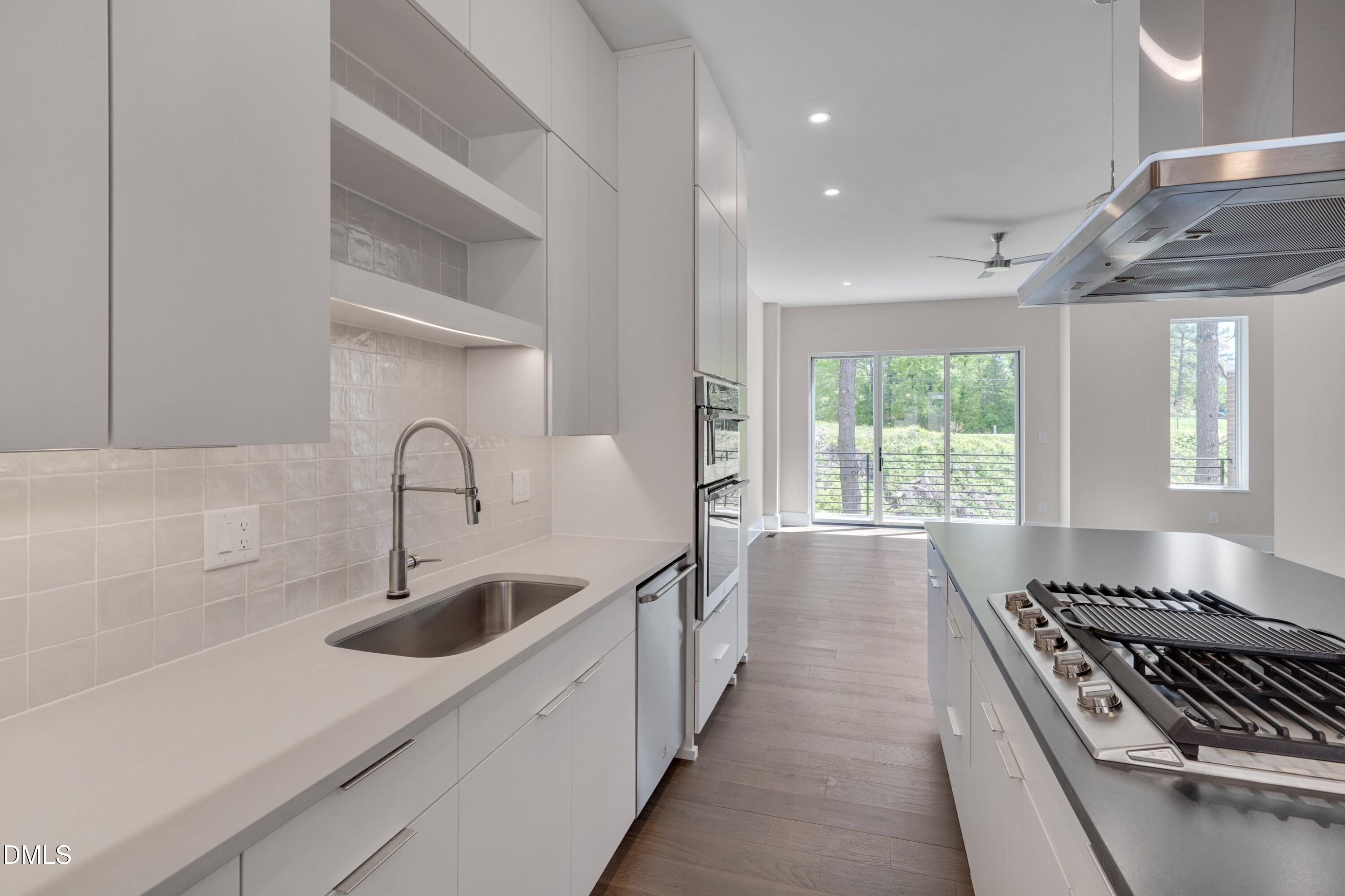 1014 Manor Way Durham, NC 27701 - Photo 15 of 38 a kitchen with sink a stove and a window