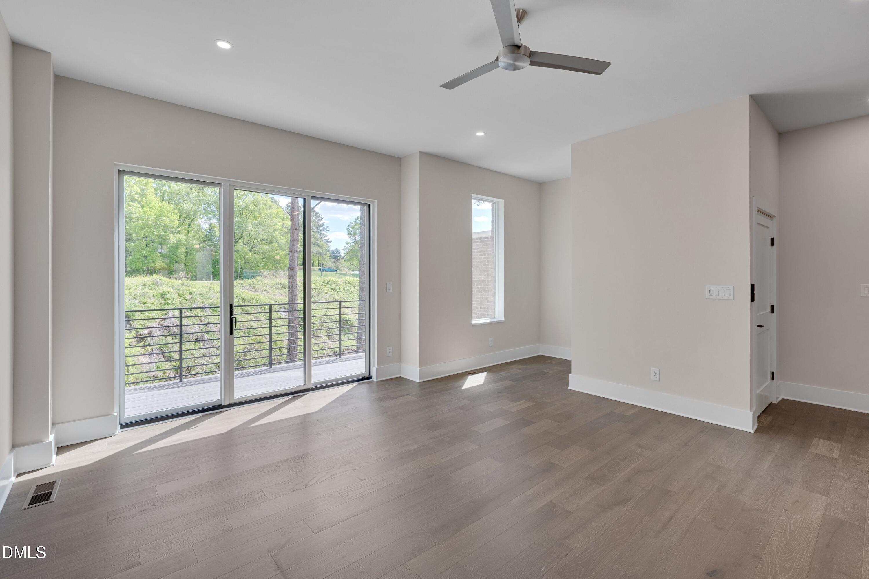 1014 Manor Way Durham, NC 27701 - Photo 19 of 38 an empty room with wooden floor and balcony