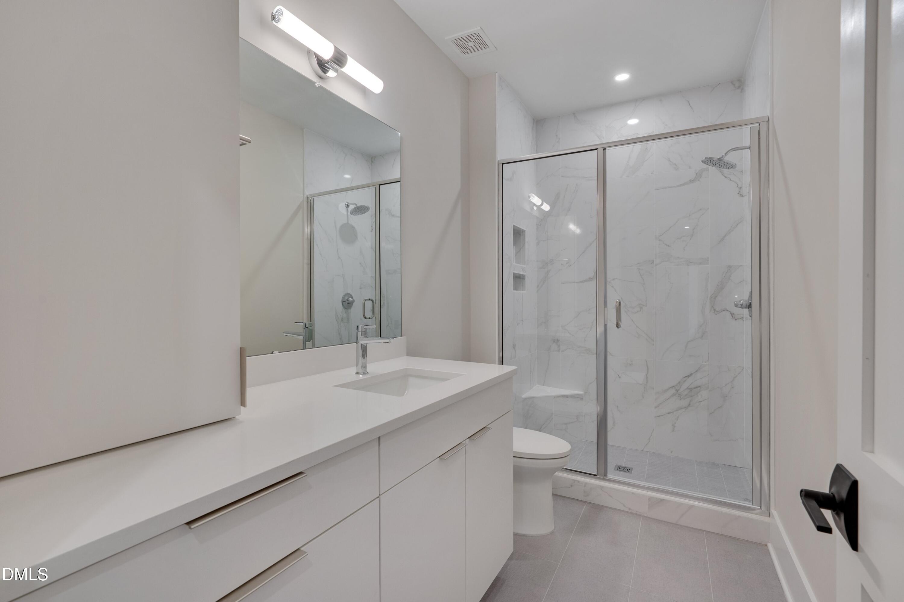 1014 Manor Way Durham, NC 27701 - Photo 24 of 38 a spacious bathroom with a shower sink mirror and toilet